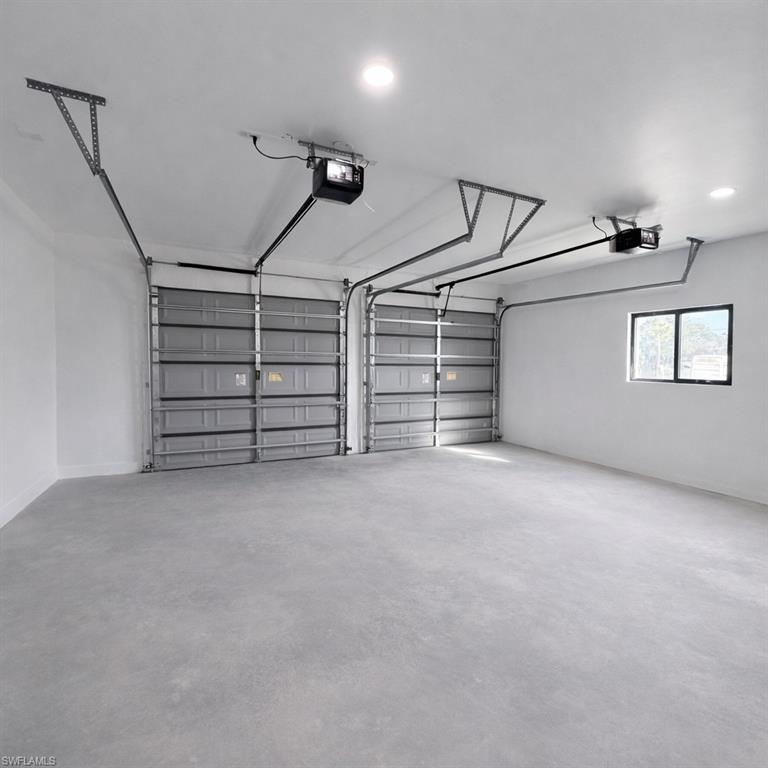Garage featuring recessed lighting and a garage door opener