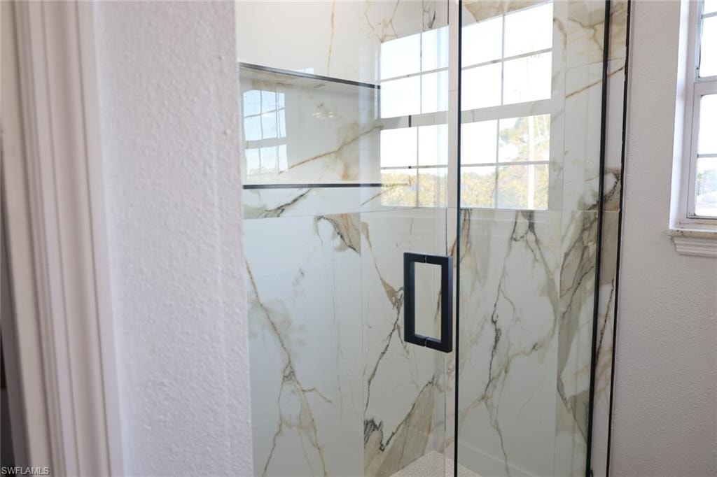 Bathroom with a marble finish shower