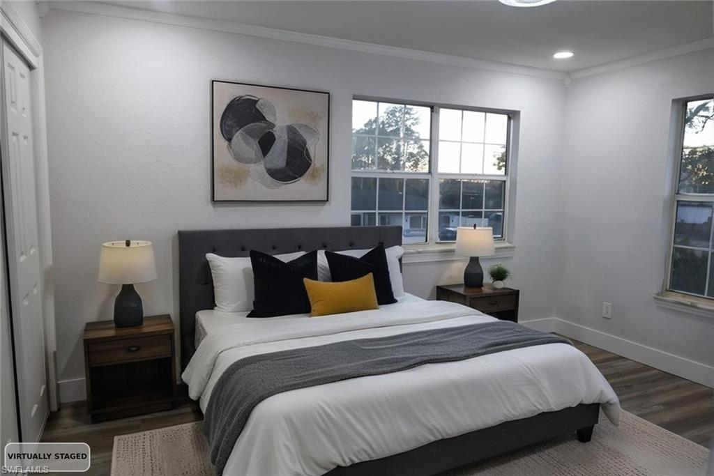 Bedroom with crown molding, dark wood-style flooring, a closet, and recessed lighting