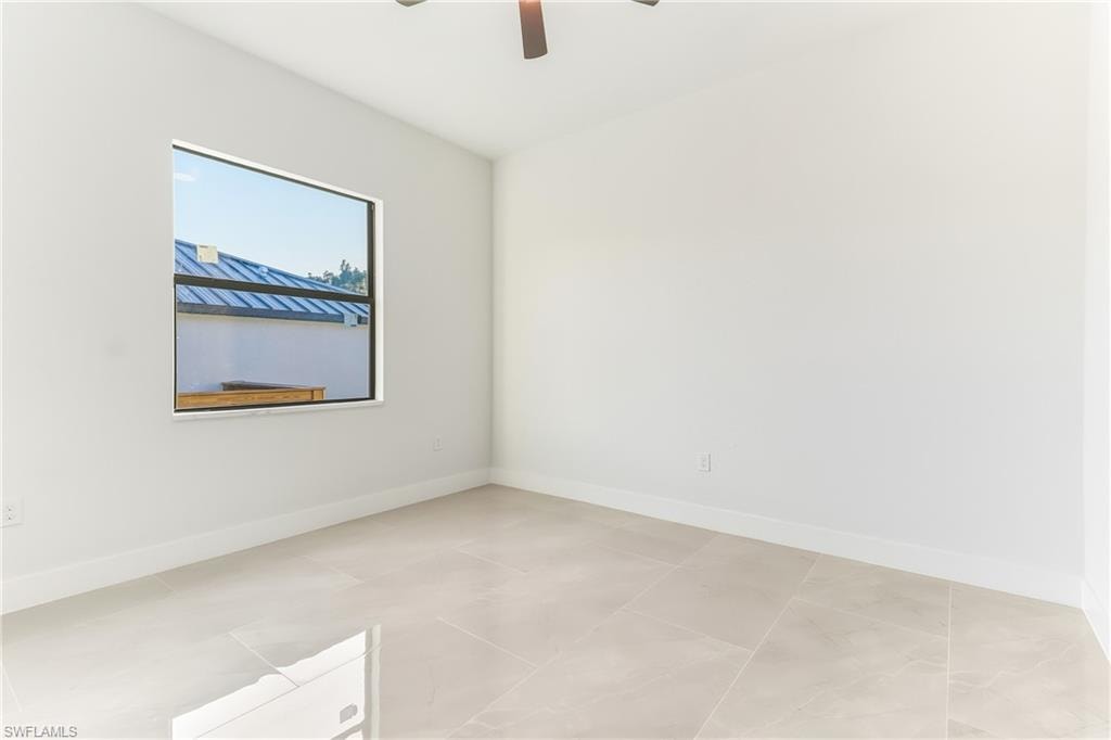 bedroom featuring baseboards and ceiling fan
