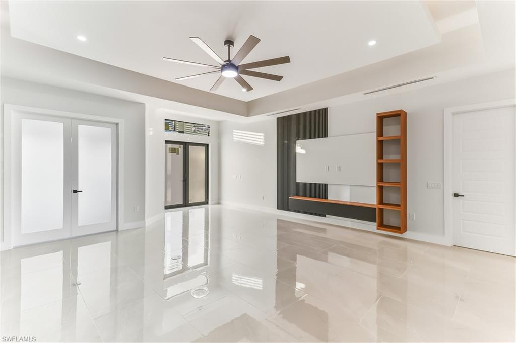 Entry dual Impact resistant storm front doors and dual french private doors to den/ office with Entertainment wall for your TV and Stereo media equipment