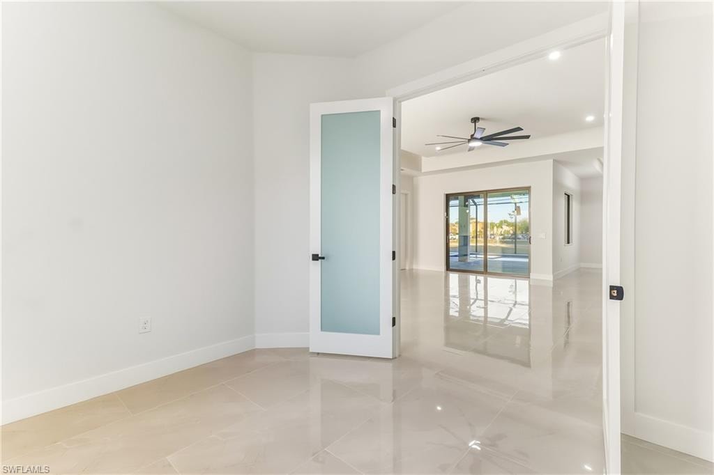 den /office  featuring a ceiling fan and dual french privacy doors