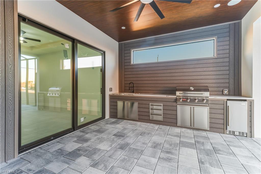 View of patio / terrace featuring exterior kitchen and ceiling fan