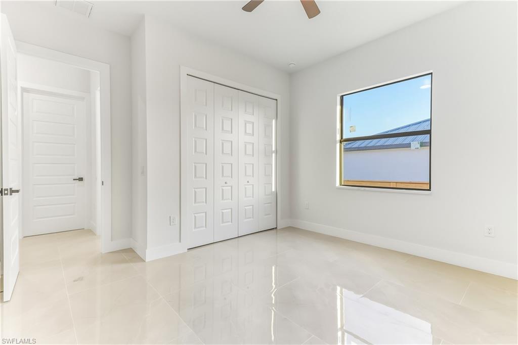 bedroom with a ceiling fan and a closet
