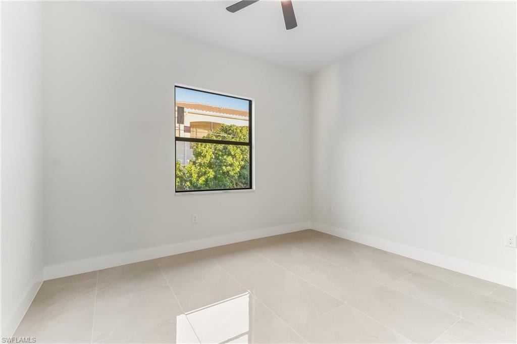 bedroom with a ceiling fan and light tile patterned floors