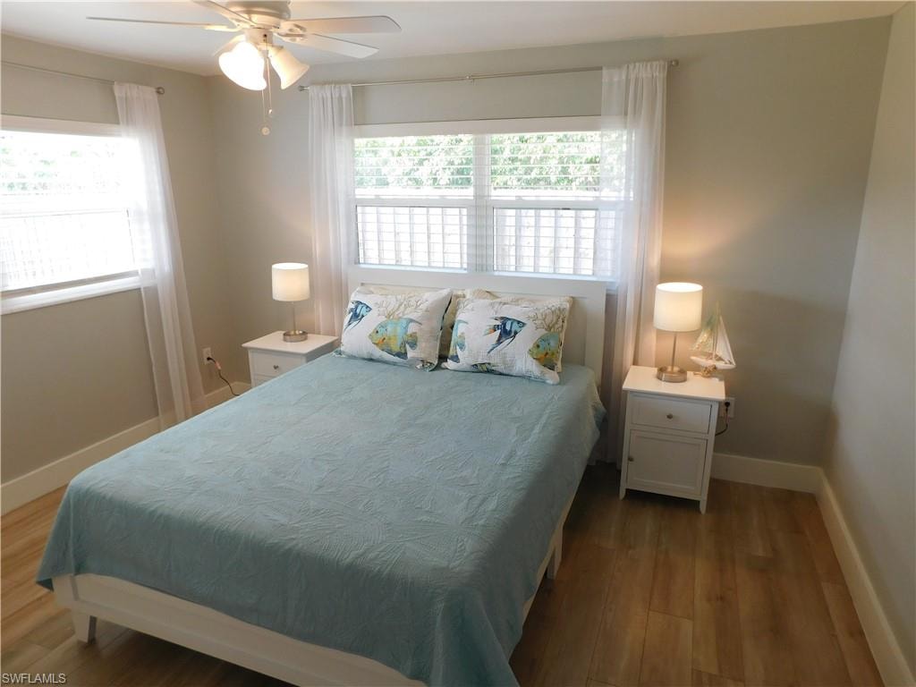 Bedroom with wood finished floors and ceiling fan