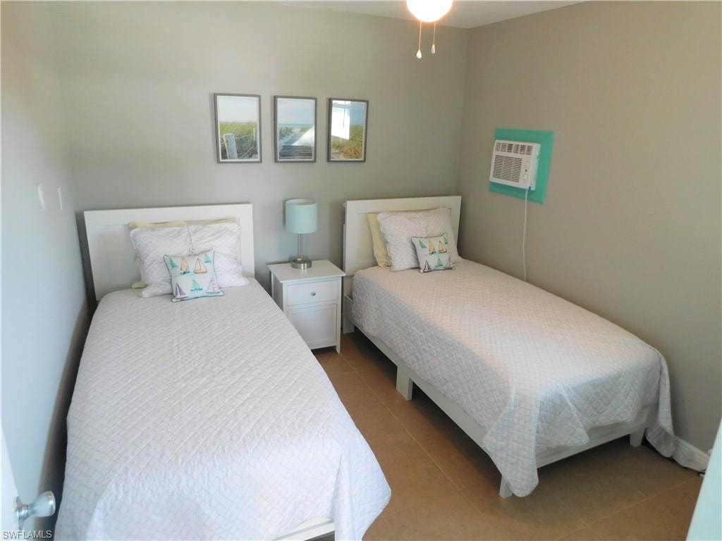 Bedroom with tile patterned flooring and ceiling fan