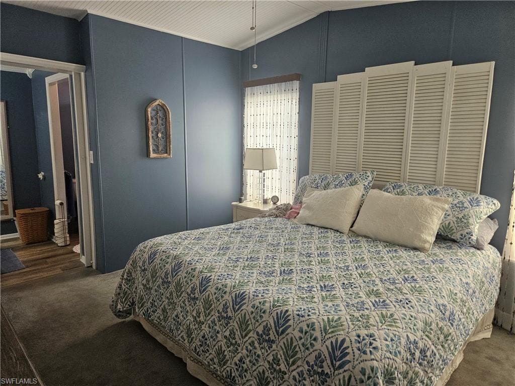 Carpeted bedroom with lofted ceiling