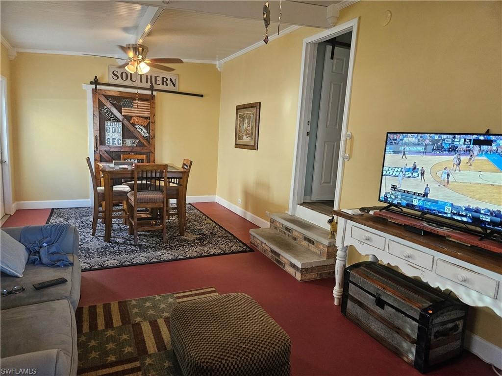 Living area with baseboards, crown molding, and a ceiling fan
