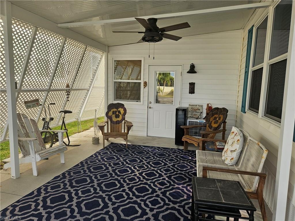 Sunroom / solarium featuring ceiling fan