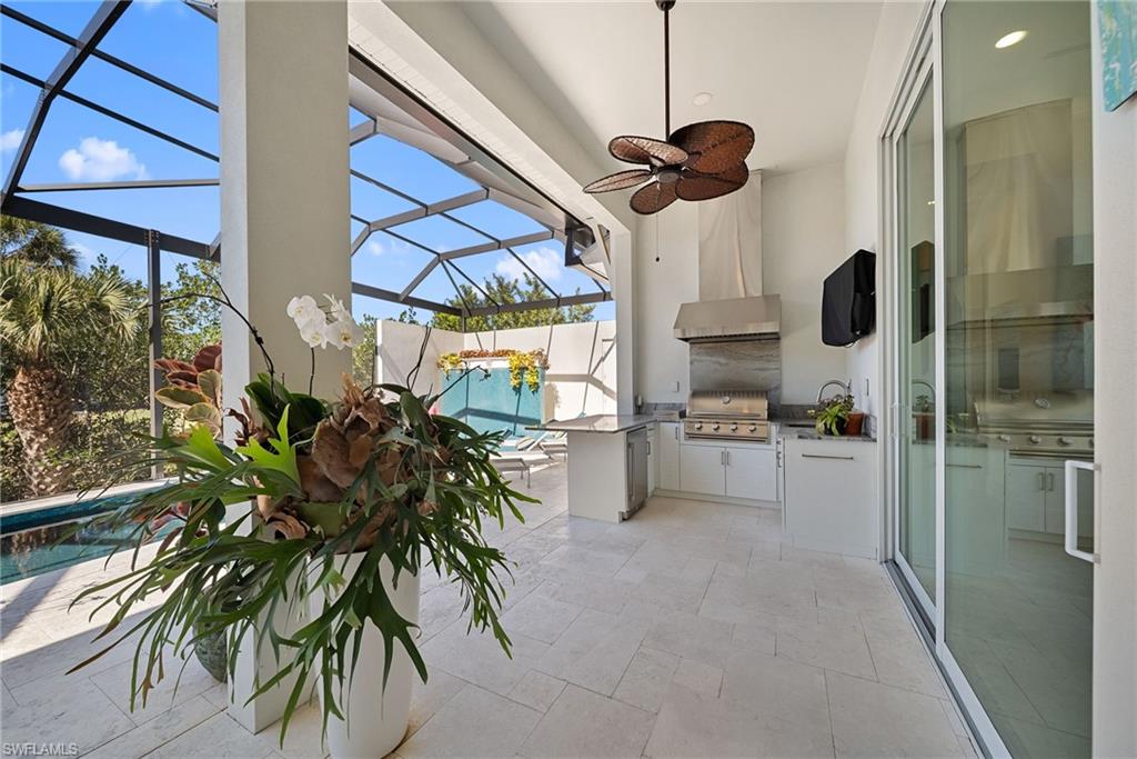 View of patio featuring a sunroom, a lanai, area for grilling, a ceiling fan, and an outdoor pool