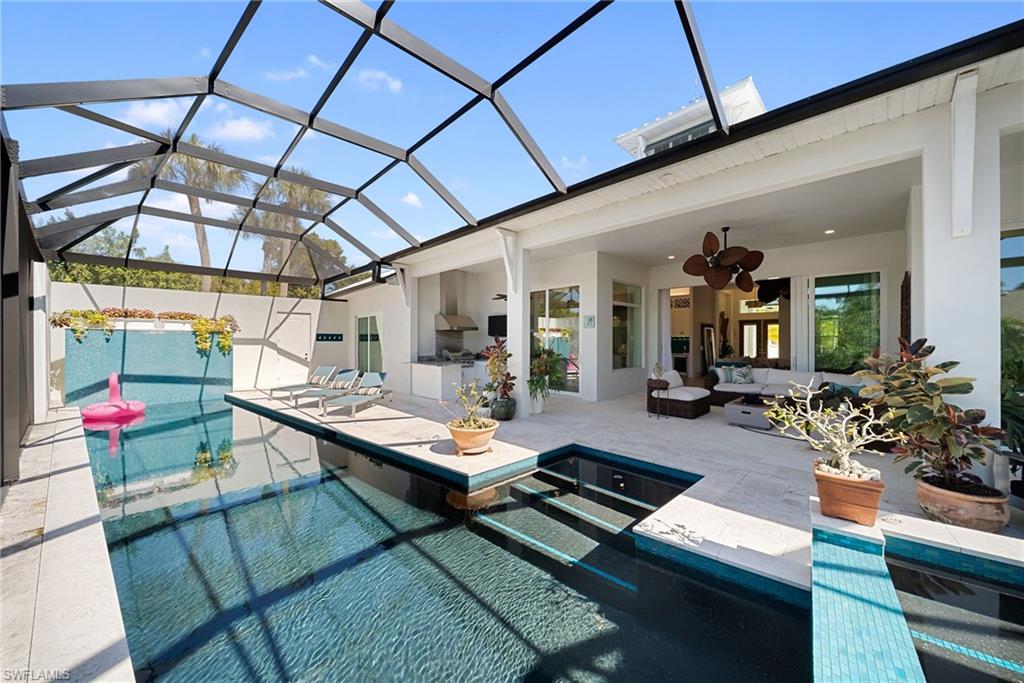 Outdoor pool featuring a sunroom, a patio, outdoor seating, and a lanai
