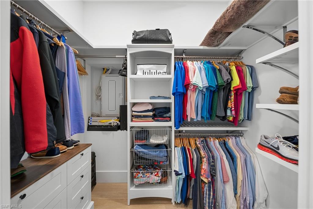 Walk in closet featuring light wood finished floors and electric panel