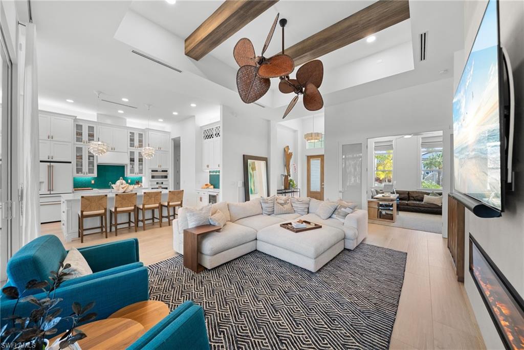 Living area featuring light wood finished floors, ceiling fan, and recessed lighting