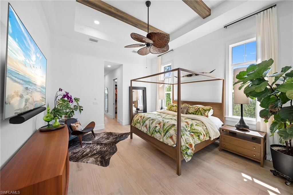 Bedroom featuring recessed lighting, light wood-type flooring, a ceiling fan, and beamed ceiling