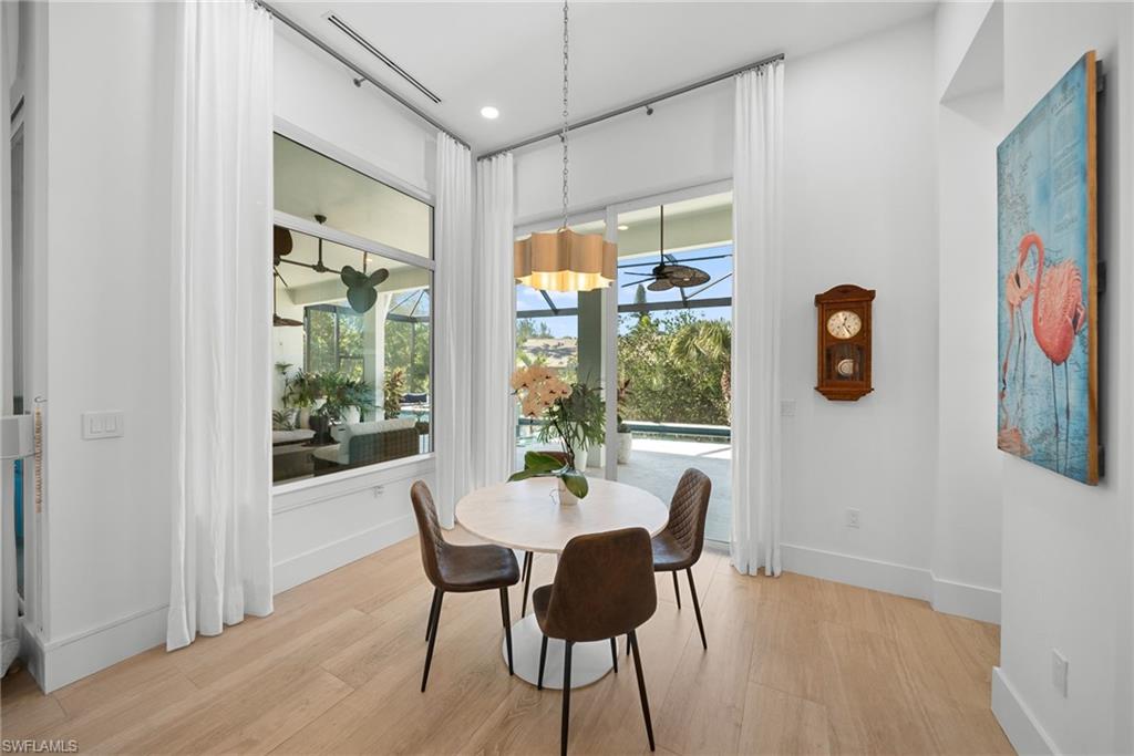 Dining area featuring a sunroom, recessed lighting, and light wood finished floors