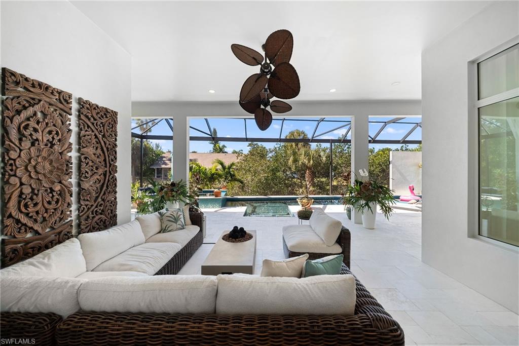 View of patio / terrace with outdoor seating, a sunroom, an outdoor pool, and glass enclosure