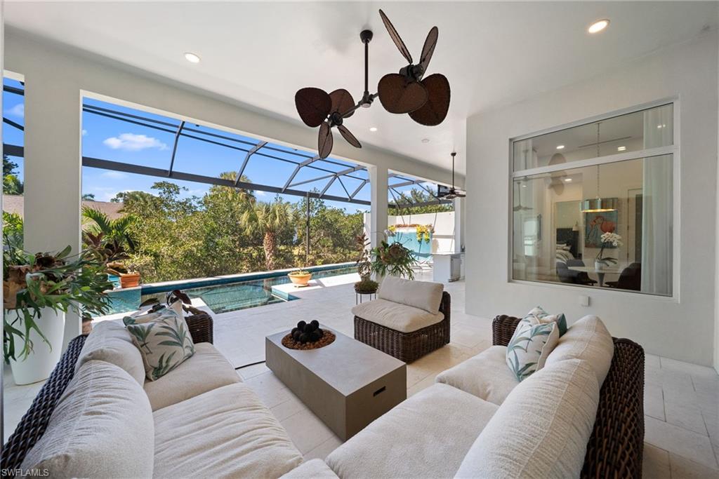 View of patio featuring an outdoor pool, a sunroom, and outdoor seating