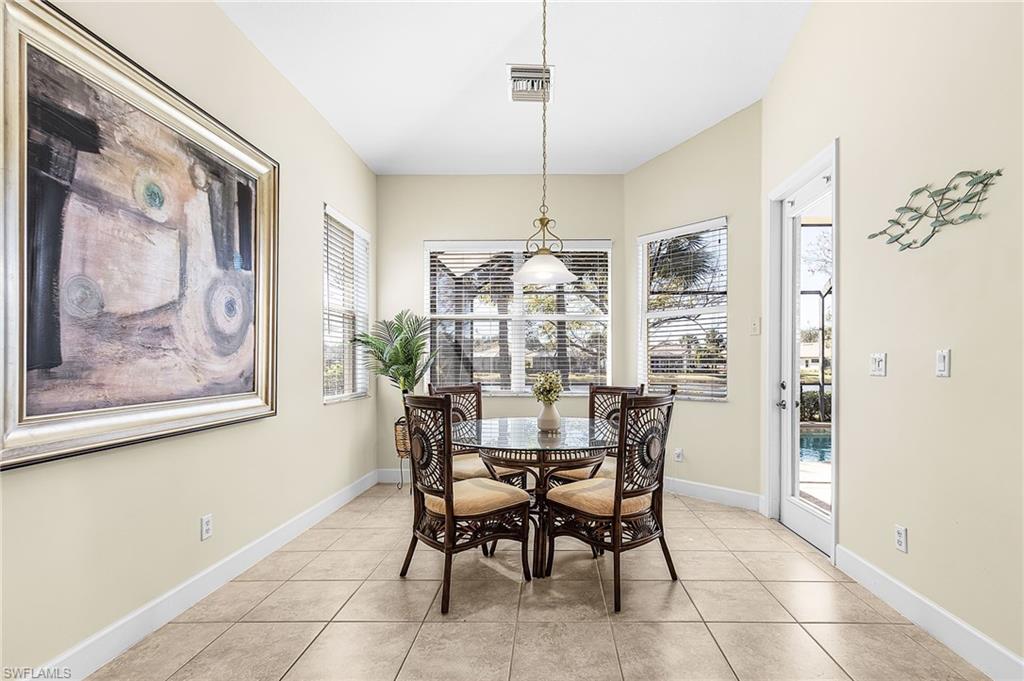 large dining area off of kitchen overlooking pool