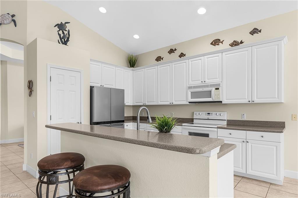 Kitchen has eating counter and is open to great room