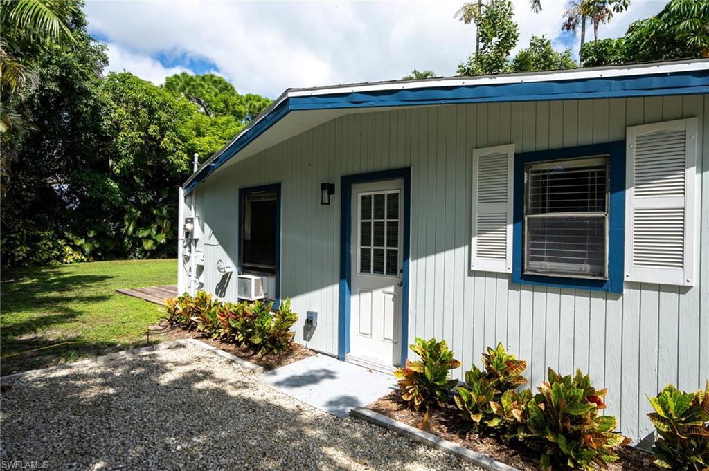 Side Entrance to property with a yard