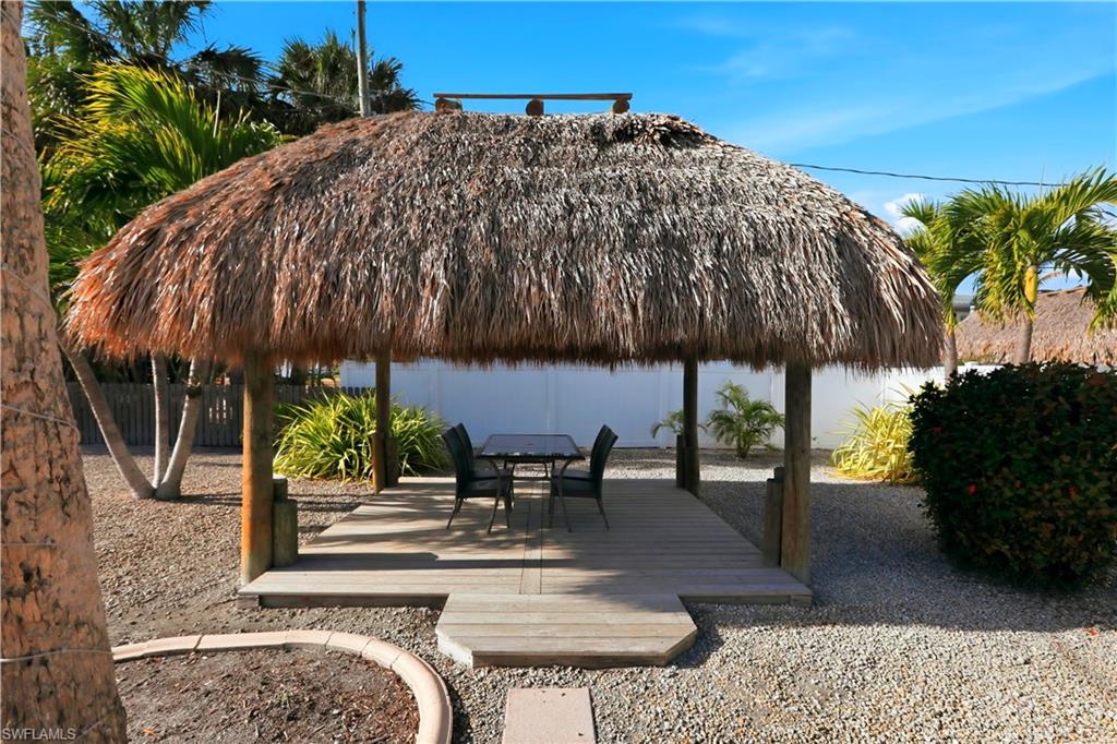 View of property's community featuring a patio area, a fenced backyard, a swimming pool, and a gazebo