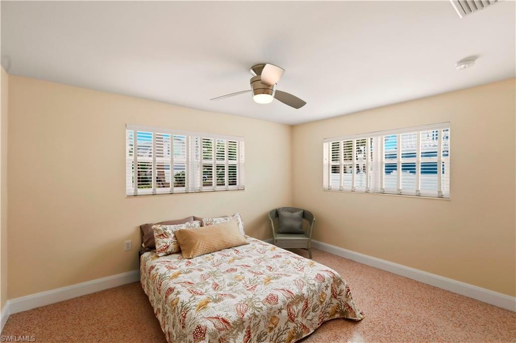 Sitting room with baseboards and ceiling fan
