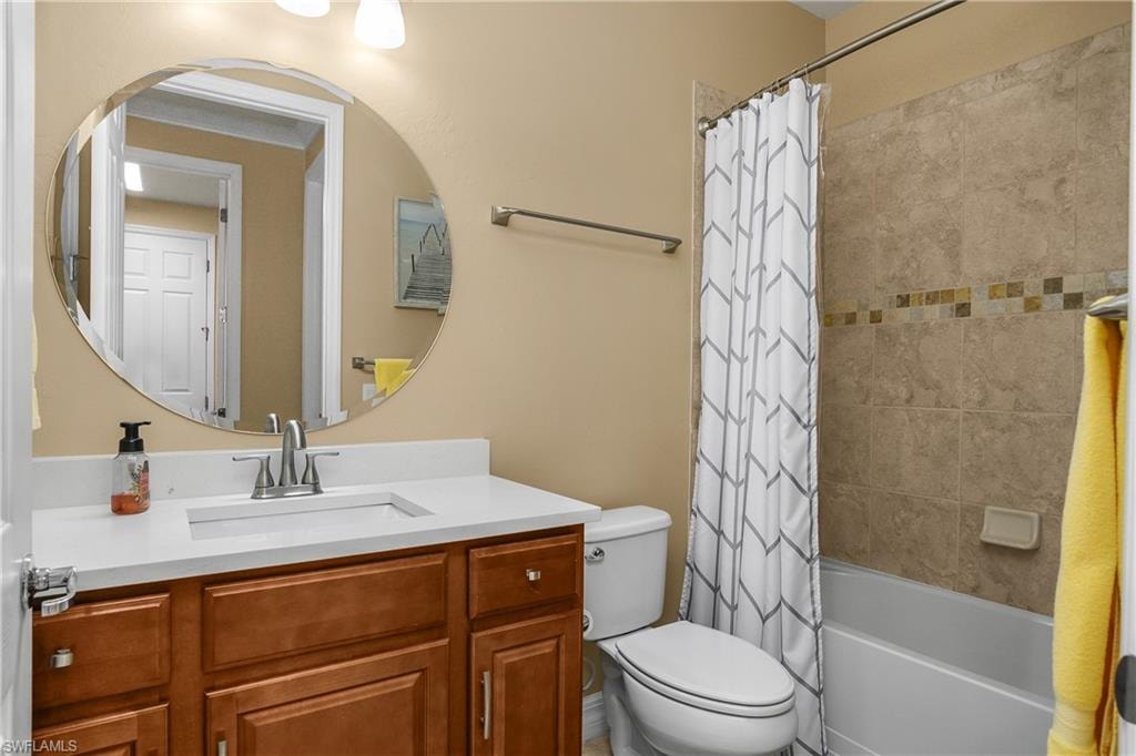 Full bathroom featuring vanity and shower / bath combo with shower curtain