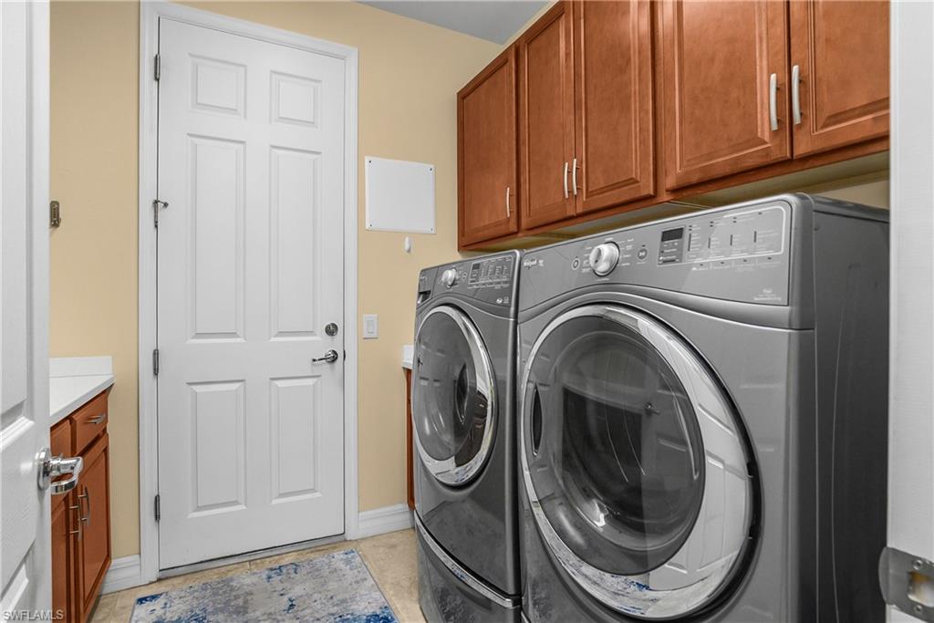 Laundry room featuring cabinet space and washer and dryer