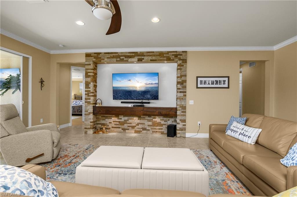 Living room featuring crown molding and ceiling fan