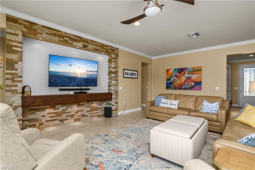 Living area featuring ceiling fan, ornamental molding, recessed lighting, and tile patterned flooring