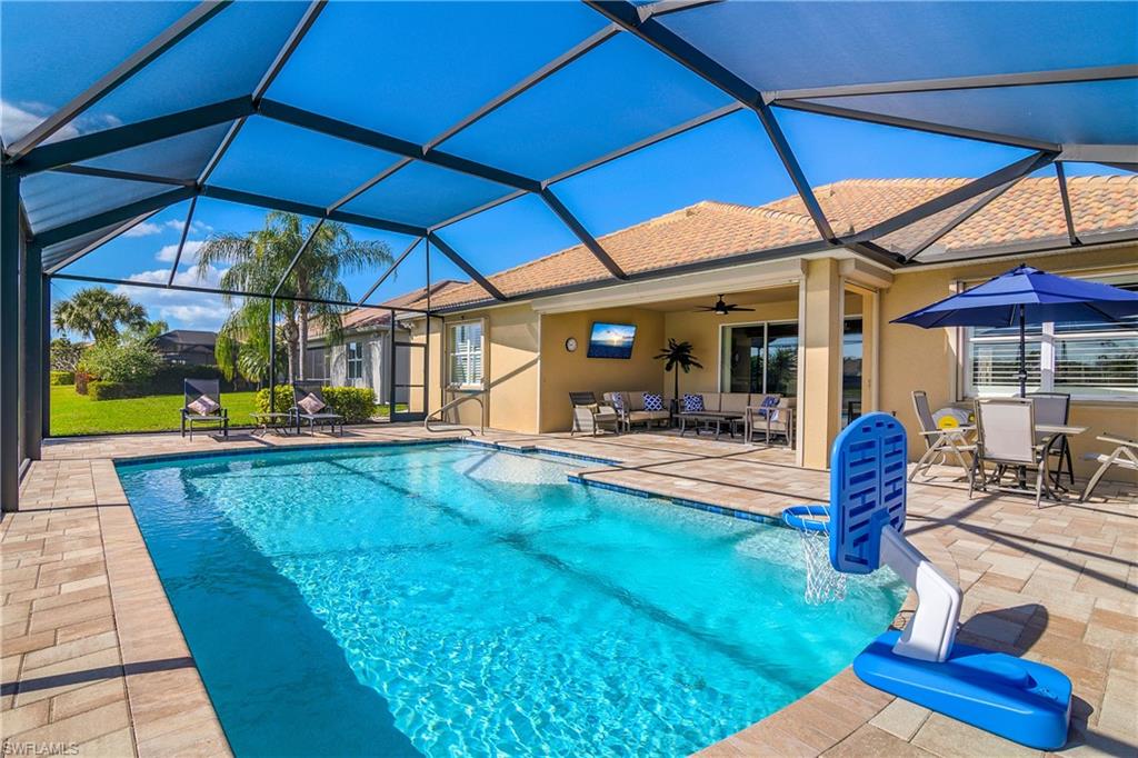 Outdoor pool with a sunroom, a patio, a lanai, and outdoor lounge area