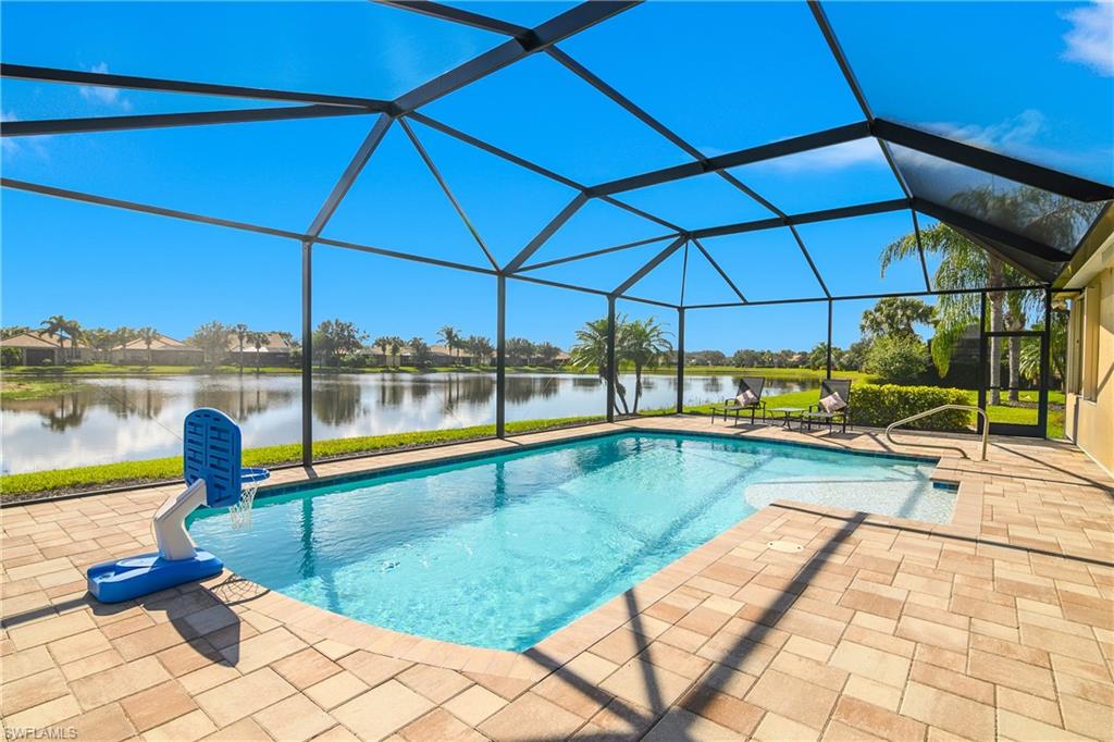 Swimming pool featuring a water view, a sunroom, a lanai, a patio, and a residential view
