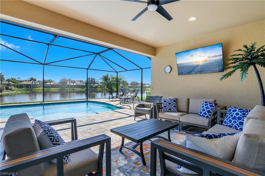 Outdoor pool featuring a sunroom, an outdoor hangout area, a patio, a lanai, and a residential view