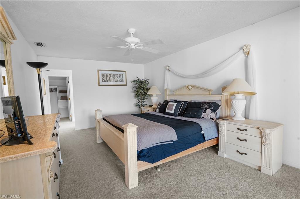 Spacious main bedroom suite features patio doors to covered lahai and pool area.