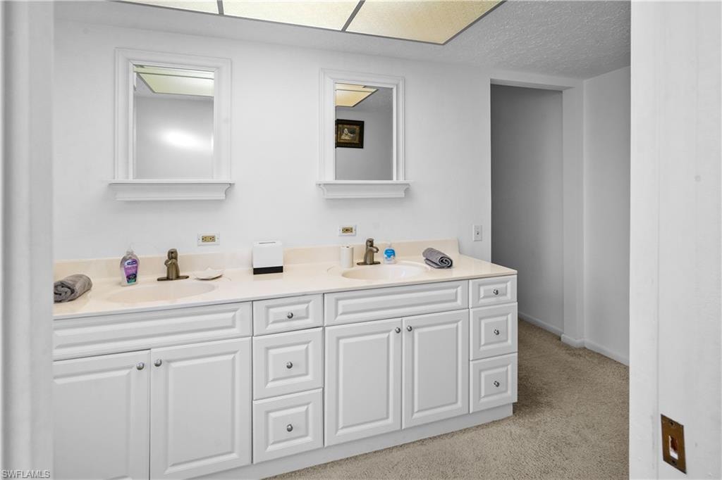 Carpeted bedroom overlooks the pool and water front, canal.