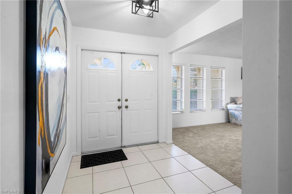 View of patio / terrace featuring two ceiling fans and outdoor dining space. The patio doors and kitchen window slide into the wall to give you full openings.