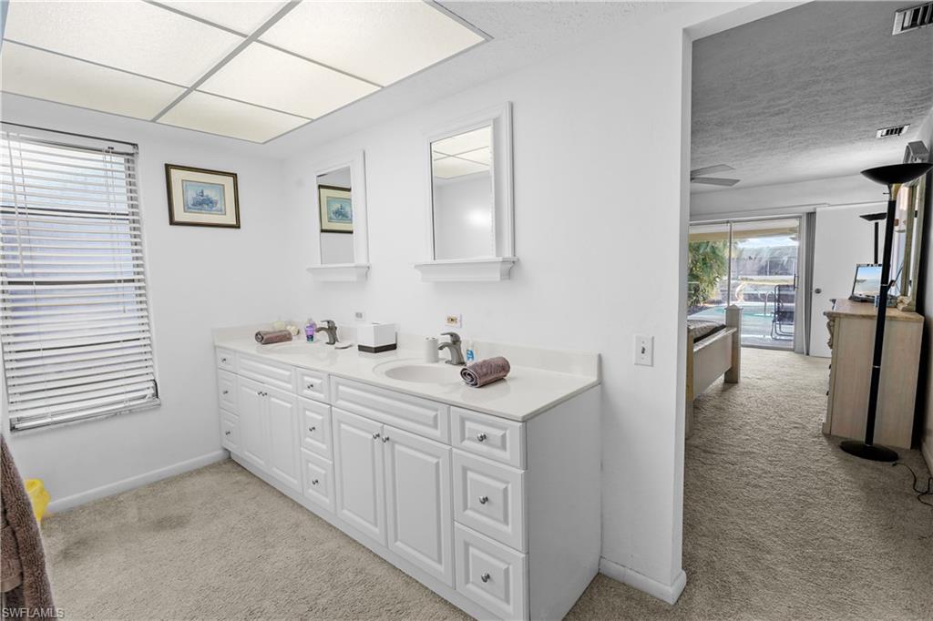 Primay private bathroom featuring a double vanity with two drawers banks.