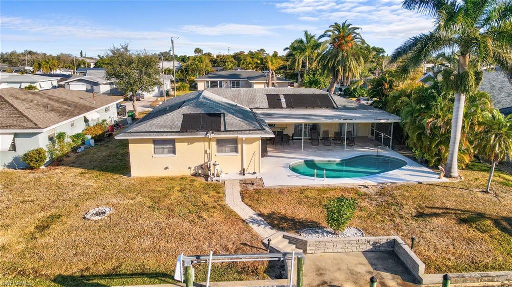 Dock area featuring boat lift, boat dock and concrete seawall provides you direct boating access to the Caloosahatchee River and Gulf.
