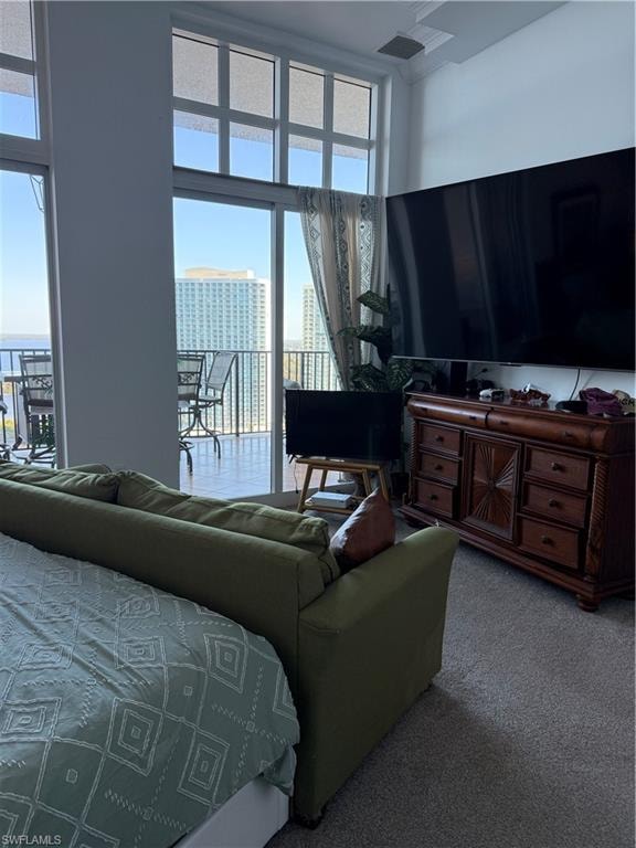 Bedroom featuring carpet and a high ceiling