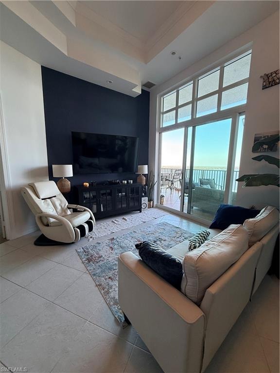 Tiled living area with ornamental molding and a tray ceiling