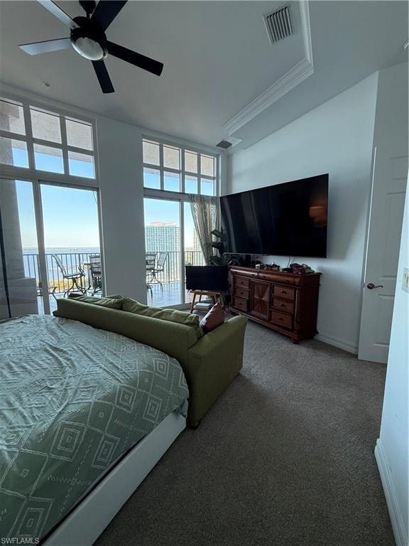 Carpeted bedroom with a ceiling fan and access to outside