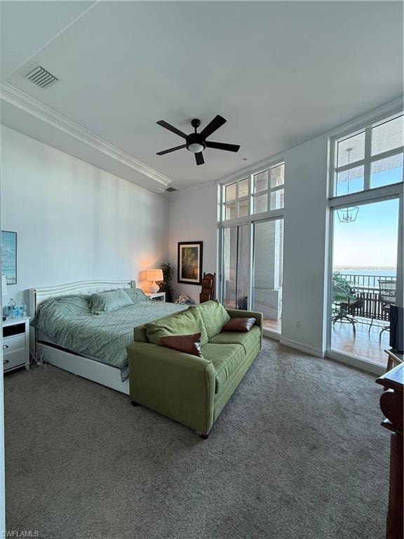 Bedroom featuring carpet, a ceiling fan, access to outside, and a water view