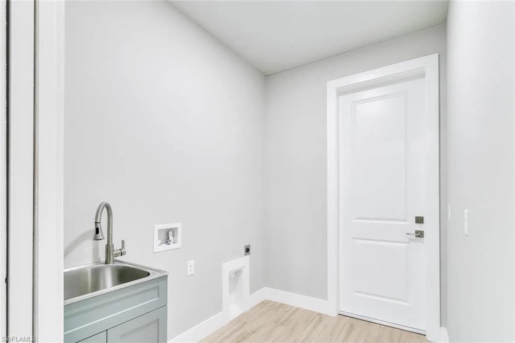 Laundry room featuring washer hookup, light wood-type flooring, and electric dryer hookup