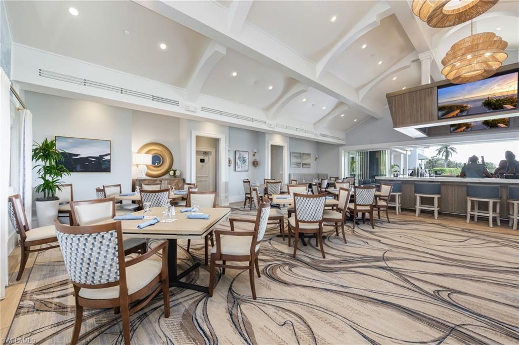 Dining room featuring lofted ceiling and recessed lighting