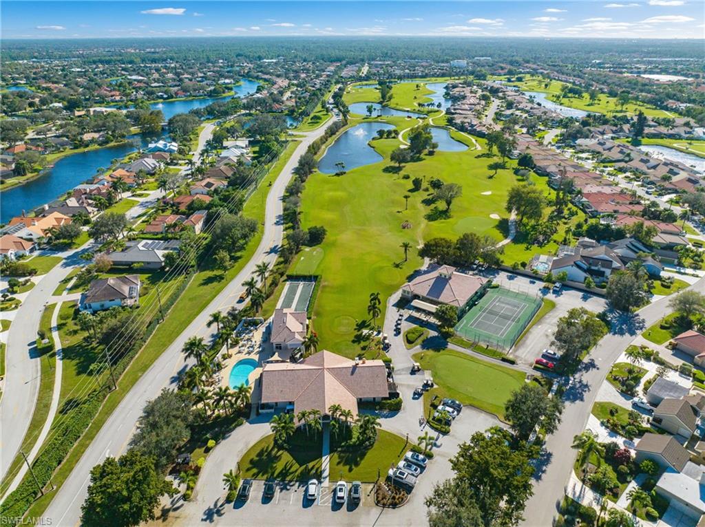 View of property location with nearby suburban area, a large body of water, and a golf club