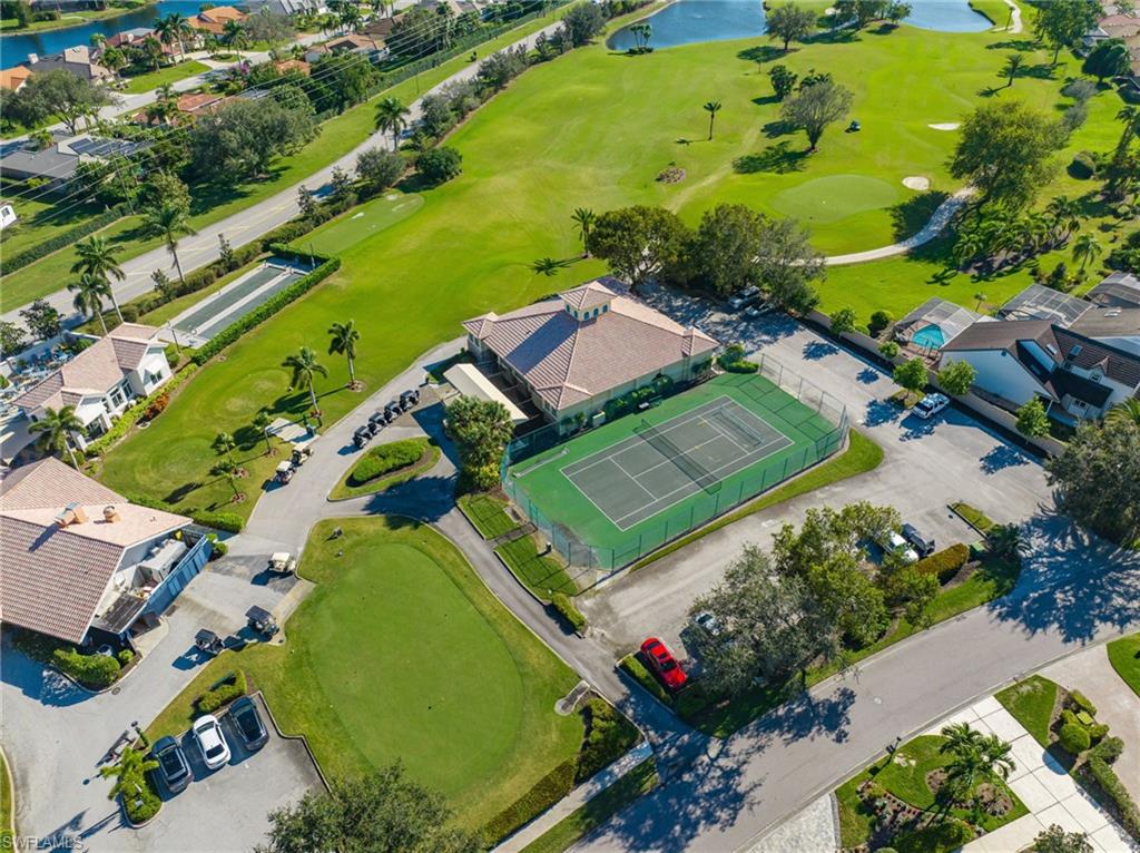 Aerial view of property's location featuring a local golf course and a large body of water