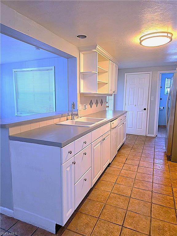 Sink side of kitchen with serving bar top to family room