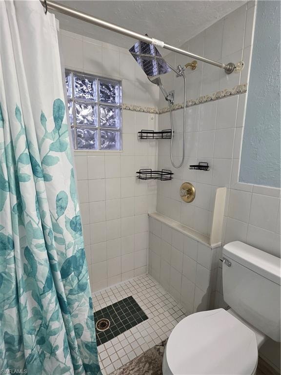Full bathroom featuring a shower stall