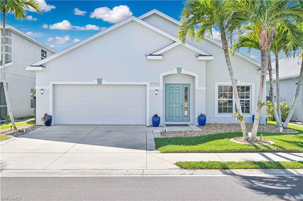 Traditional home featuring stucco siding, concrete driveway, and a garage